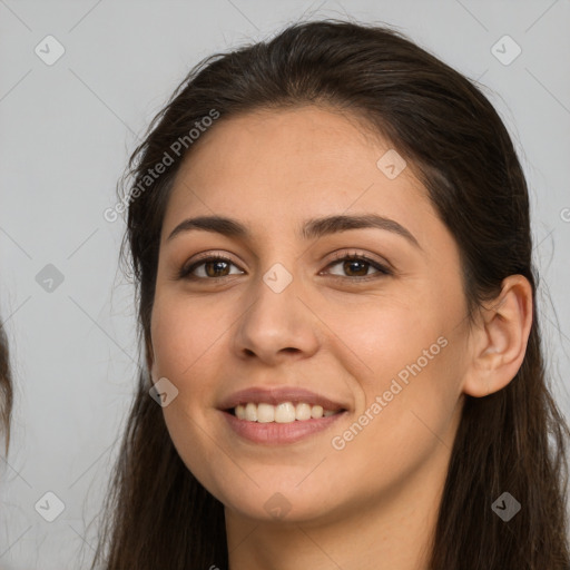 Joyful white young-adult female with long  brown hair and brown eyes