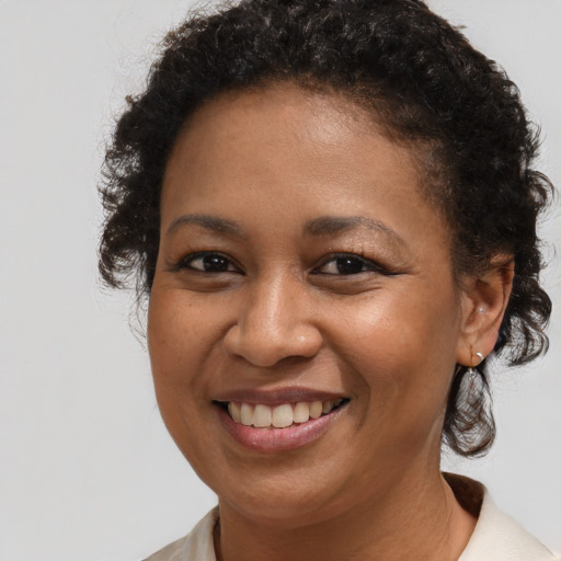 Joyful black young-adult female with medium  brown hair and brown eyes