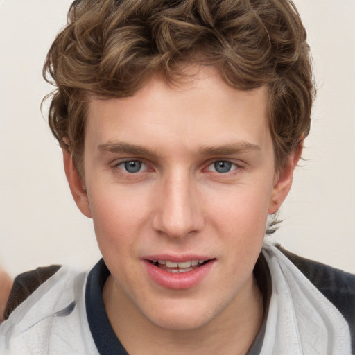 Joyful white young-adult male with short  brown hair and blue eyes