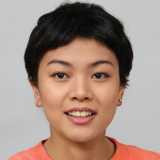 Joyful asian young-adult female with short  black hair and brown eyes