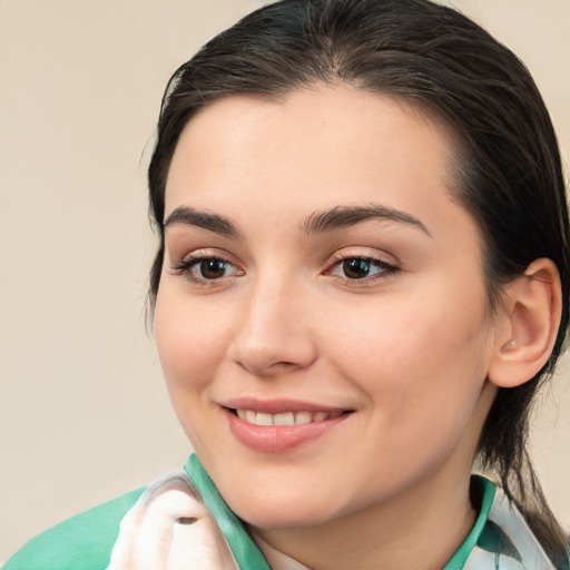 Joyful white young-adult female with medium  brown hair and brown eyes