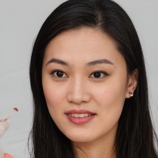 Joyful asian young-adult female with long  brown hair and brown eyes