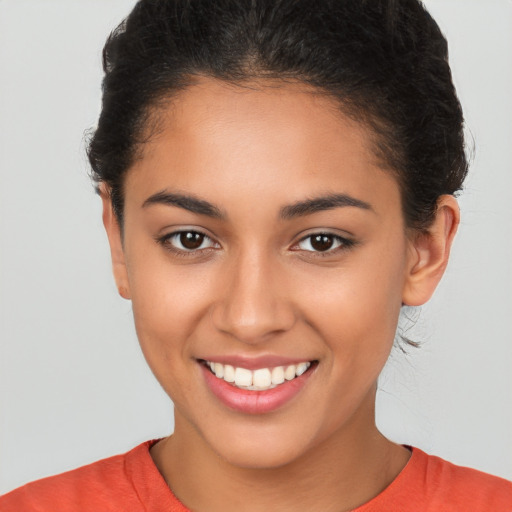 Joyful latino young-adult female with short  brown hair and brown eyes