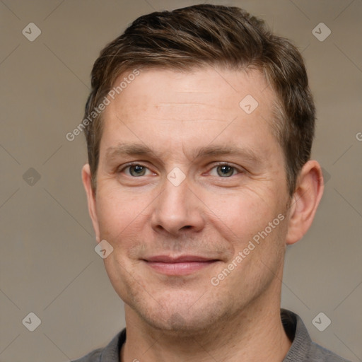 Joyful white adult male with short  brown hair and grey eyes