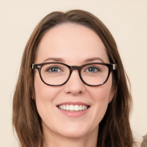 Joyful white young-adult female with long  brown hair and green eyes