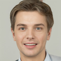 Joyful white young-adult male with short  brown hair and grey eyes