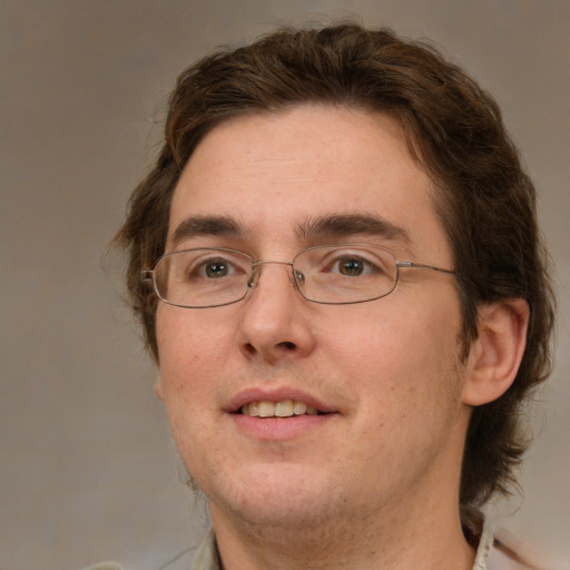 Joyful white adult male with short  brown hair and green eyes