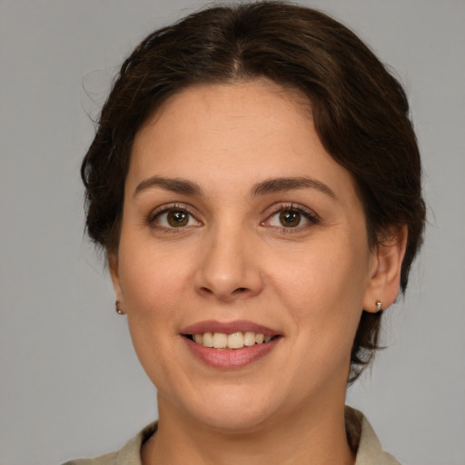 Joyful white young-adult female with medium  brown hair and grey eyes