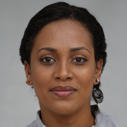 Joyful black young-adult female with medium  brown hair and brown eyes