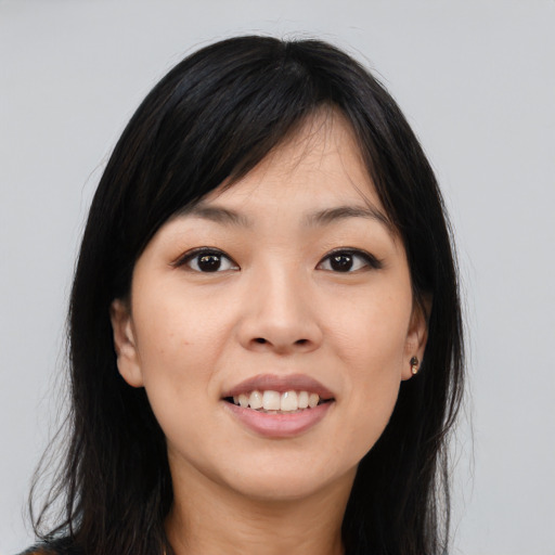 Joyful white young-adult female with long  black hair and brown eyes