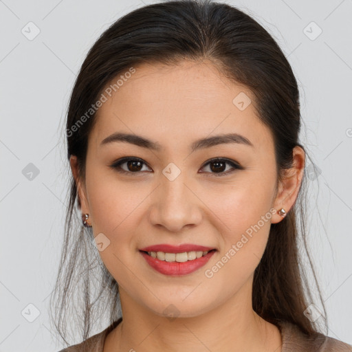 Joyful latino young-adult female with long  brown hair and brown eyes