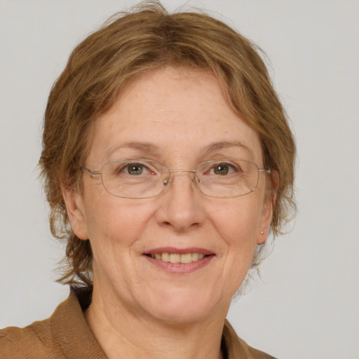 Joyful white middle-aged female with medium  brown hair and blue eyes