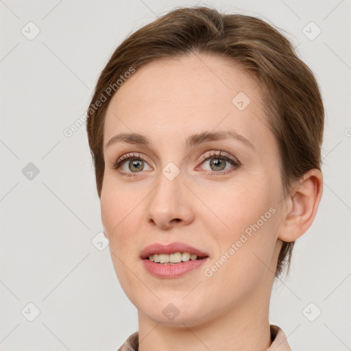 Joyful white young-adult female with short  brown hair and grey eyes