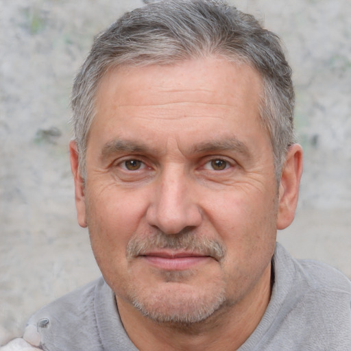 Joyful white middle-aged male with short  gray hair and brown eyes