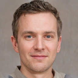 Joyful white adult male with short  brown hair and grey eyes