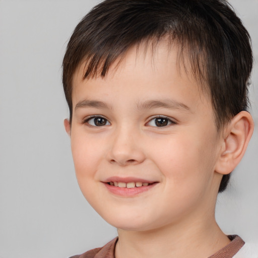 Joyful white child male with short  brown hair and brown eyes