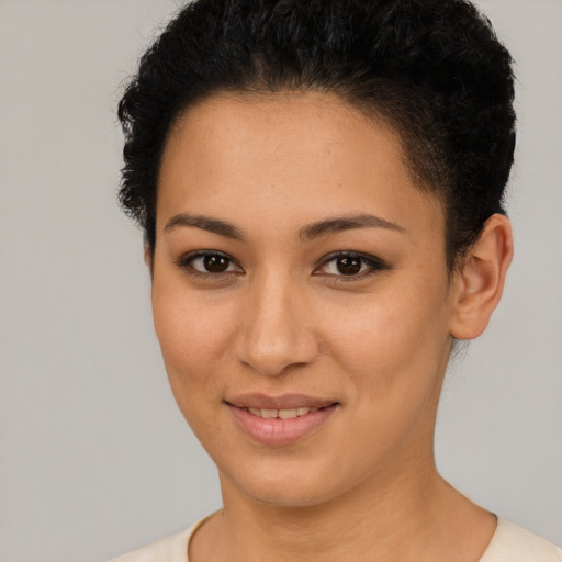 Joyful latino young-adult female with short  brown hair and brown eyes