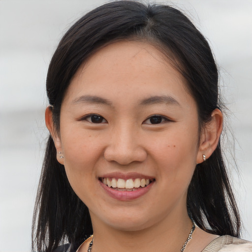 Joyful asian young-adult female with medium  brown hair and brown eyes