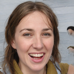 Joyful white adult female with medium  brown hair and blue eyes