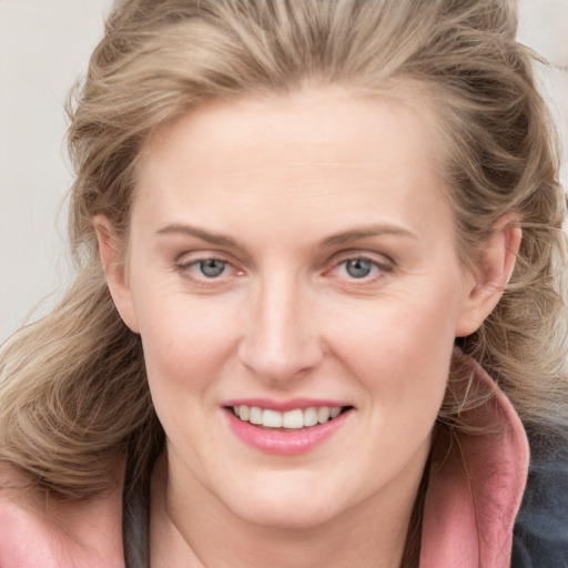 Joyful white young-adult female with medium  brown hair and blue eyes