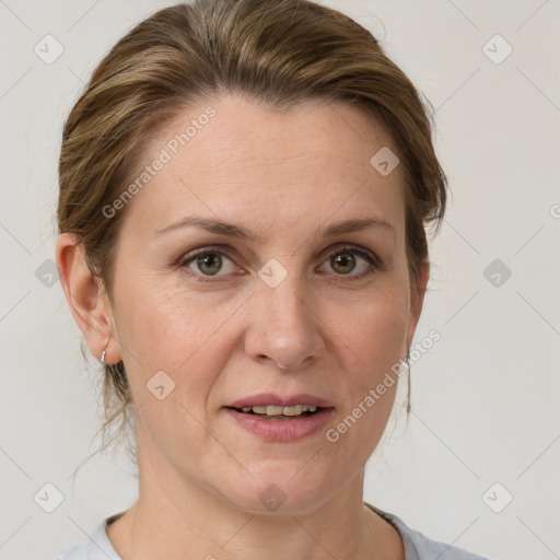 Joyful white adult female with medium  brown hair and grey eyes