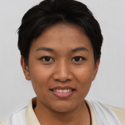 Joyful asian young-adult female with short  brown hair and brown eyes