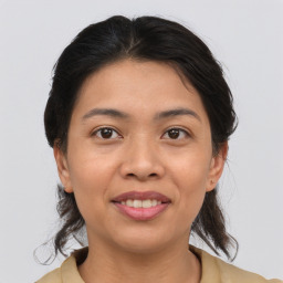 Joyful asian young-adult female with medium  brown hair and brown eyes