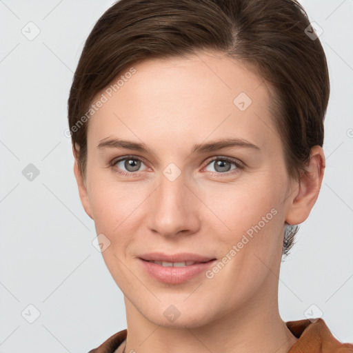 Joyful white young-adult female with short  brown hair and grey eyes