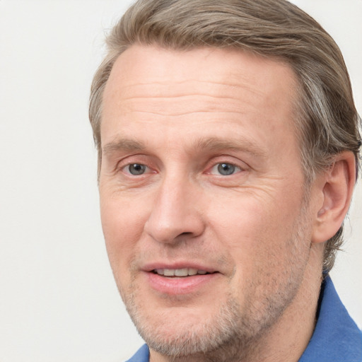 Joyful white adult male with short  brown hair and grey eyes