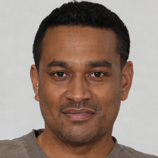 Neutral latino adult male with short  black hair and brown eyes