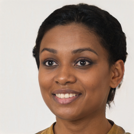 Joyful latino young-adult female with short  black hair and brown eyes