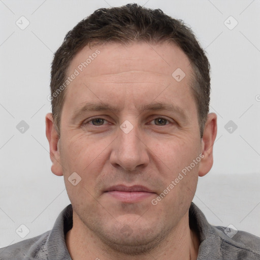 Joyful white adult male with short  brown hair and grey eyes