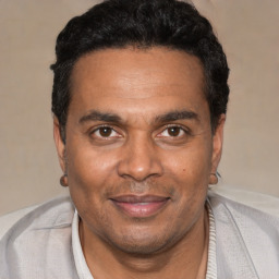 Joyful black adult male with short  black hair and brown eyes