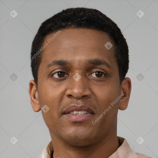 Joyful black young-adult male with short  brown hair and brown eyes