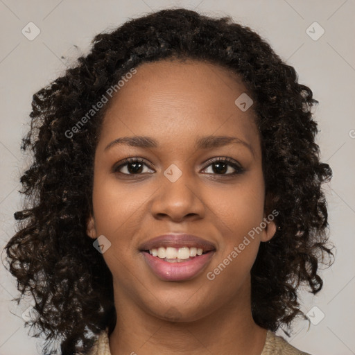 Joyful black young-adult female with long  brown hair and brown eyes