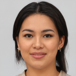 Joyful latino young-adult female with medium  brown hair and brown eyes