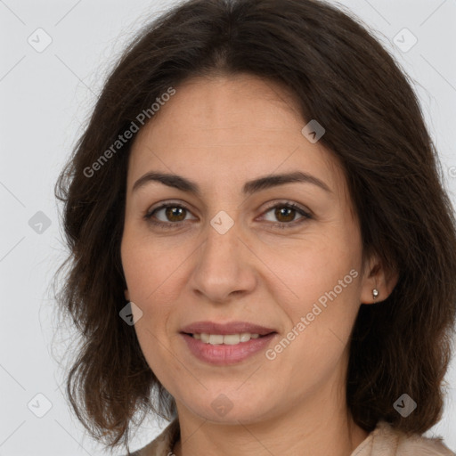 Joyful white adult female with long  brown hair and brown eyes