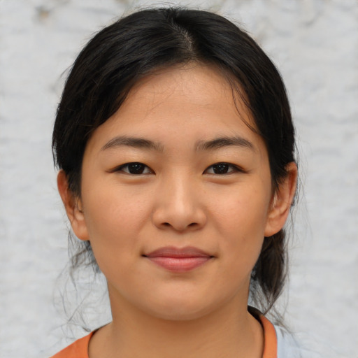 Joyful asian young-adult female with medium  brown hair and brown eyes