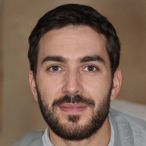 Joyful white young-adult male with short  black hair and brown eyes