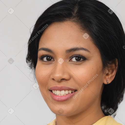 Joyful latino young-adult female with medium  brown hair and brown eyes