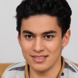 Joyful latino young-adult male with short  brown hair and brown eyes