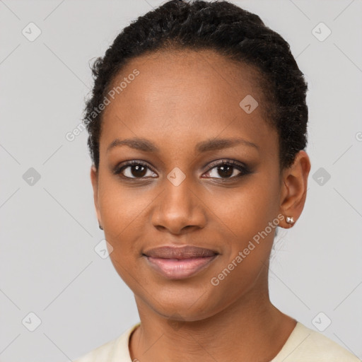 Joyful black young-adult female with short  black hair and brown eyes