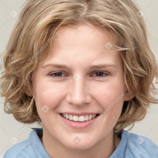 Joyful white young-adult female with medium  brown hair and blue eyes