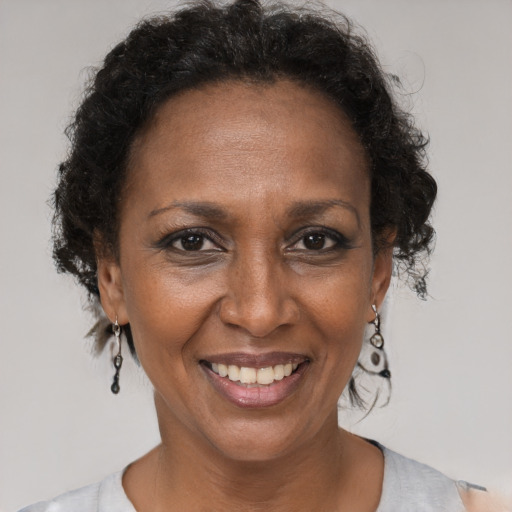 Joyful black adult female with short  brown hair and brown eyes