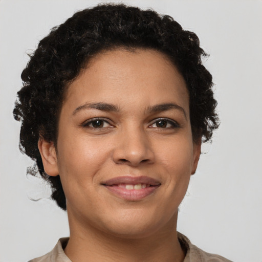 Joyful latino young-adult female with short  brown hair and brown eyes