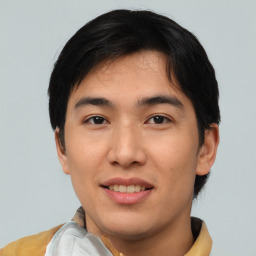 Joyful asian young-adult male with short  black hair and brown eyes