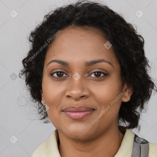 Joyful black young-adult female with long  brown hair and brown eyes