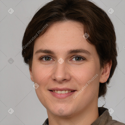 Joyful white young-adult female with short  brown hair and grey eyes