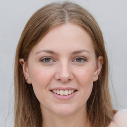 Joyful white young-adult female with long  brown hair and grey eyes