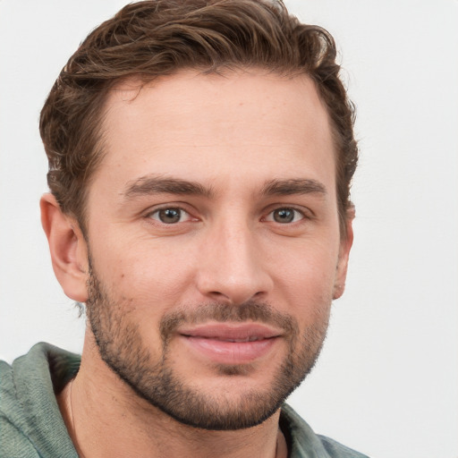 Joyful white young-adult male with short  brown hair and grey eyes